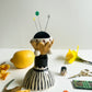 Folk lady pin cushion figurine